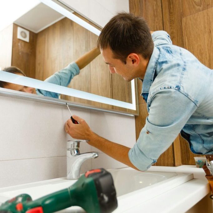 man installing custom mirror